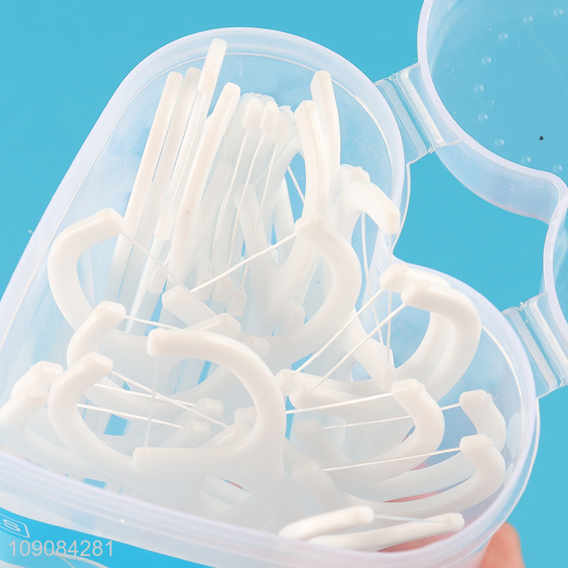Low price heart shape plastic box dental flosser for teeth cleaning